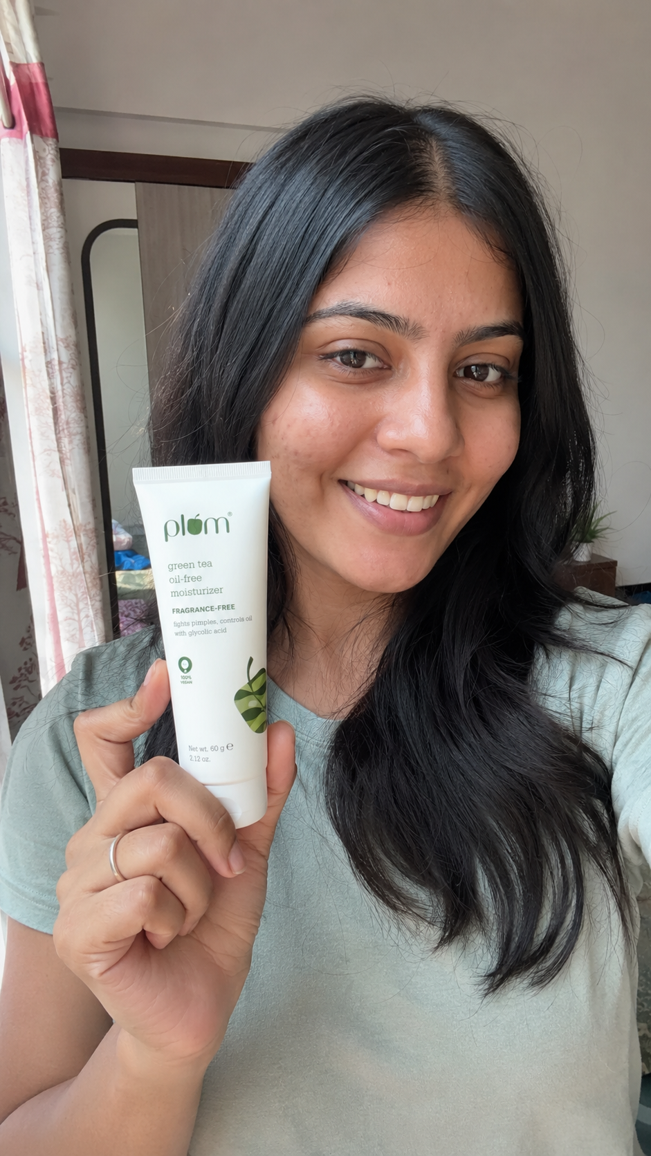 Indian influencer holding moisturiser product